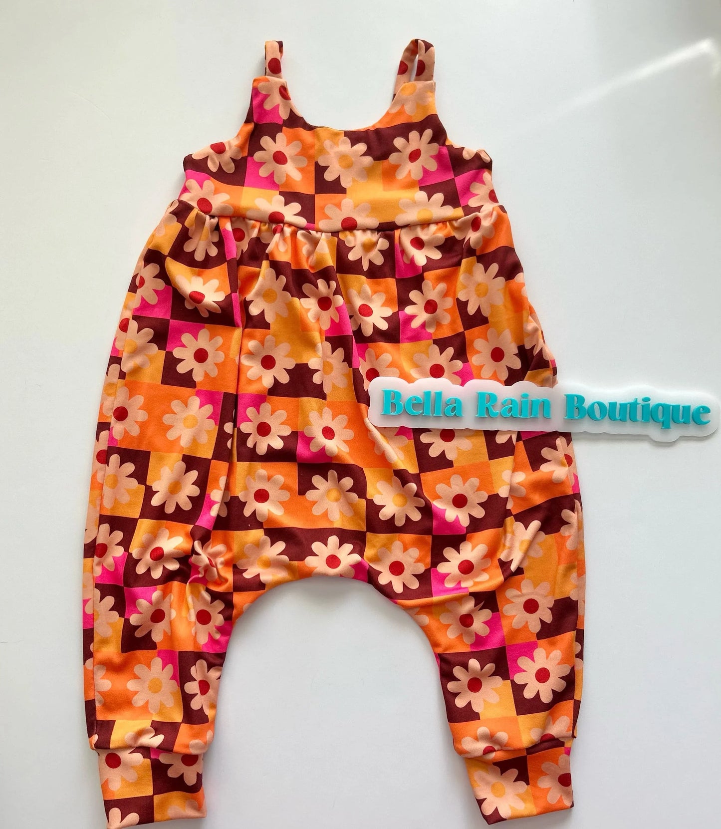 Kids bright floral strappy romper is effortless and fun!! Meet your new go to piece for mixing and matching. Layer it with a tee underneath for a casual vibe, or wear it solo for those warmer days.