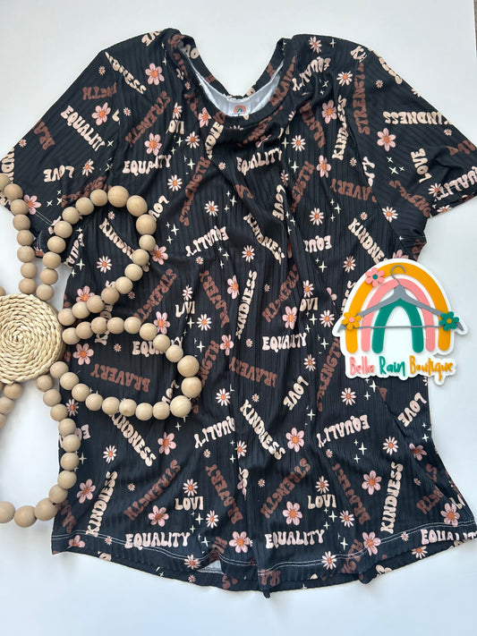 Adult black history month tee with white text and floral patterns on a white background. 