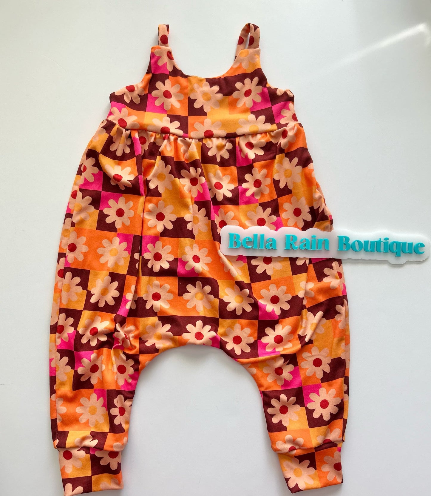 Kids bright floral strappy romper is effortless and fun!! Meet your new go to piece for mixing and matching. Layer it with a tee underneath for a casual vibe, or wear it solo for those warmer days. 