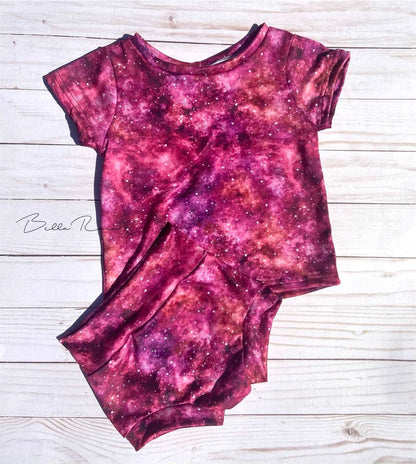 Galaxy Tee/BummiesThis Galaxy Basic Tee &amp; Bummies set is perfect for your little one's wardrobe. The set features a soft, lightweight fabric with a vibrant pink and purple galaxy 